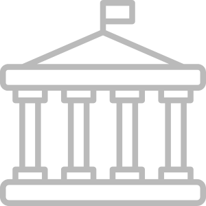 Government Staffing: A gray outline of a government building with a flag on top, symbolizing institutions, public administration, or governance.