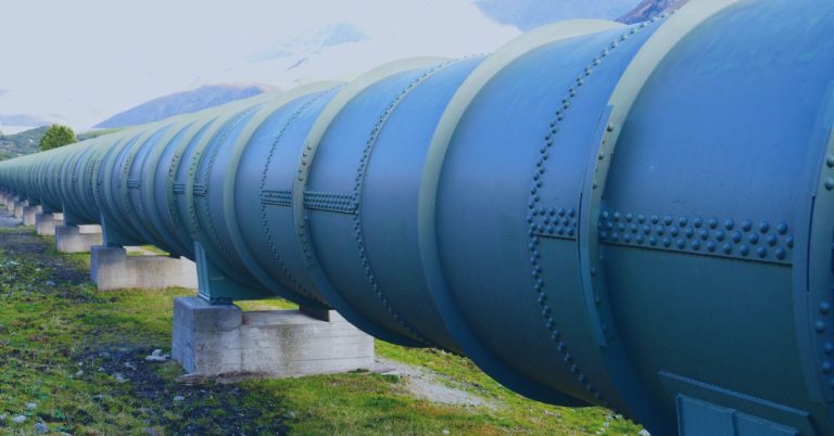 Pipeline Management: A large industrial pipeline stretching into the distance, supported by concrete pillars, with mountains and greenery in the background.