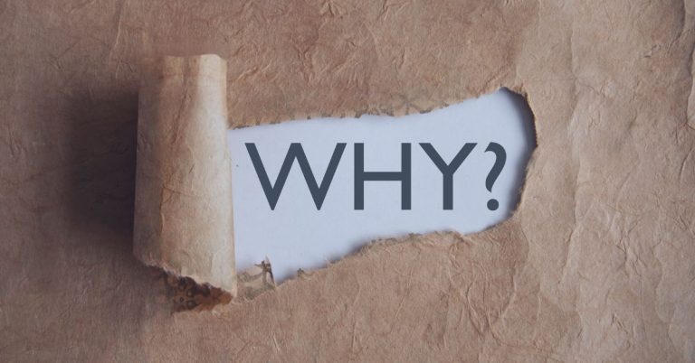 Talent Acquisition Process: A piece of brown, textured paper is torn open, revealing the word "WHY?" in bold, dark letters on a white background. The image conveys curiosity, questioning, or the search for deeper meaning.